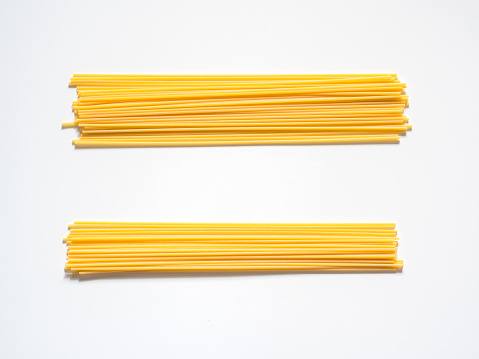 Dry spaghetti on a white background for the menu. Geometric background. Flat lay, copy space, top view