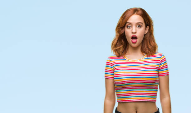 istock Young beautiful woman over isolated background afraid and shocked with surprise expression, fear and excited face. 1046560666