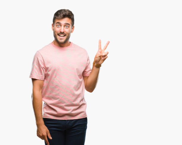 istock Young handsome man over isolated background smiling with happy face winking at the camera doing victory sign. Number two. 1046566522