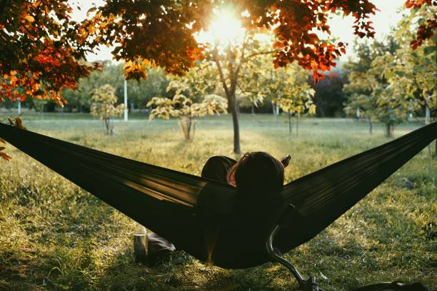 istock Woman Relaxing In Hammock At Park 1046566554
