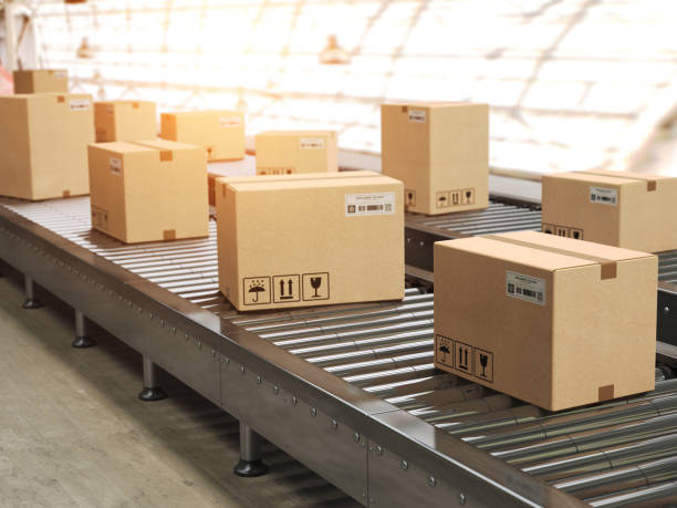 istock Conveyor line with cadrboard boxes on it in distribution warehouse, Delivery, storage and transportation service concept. 1046569828