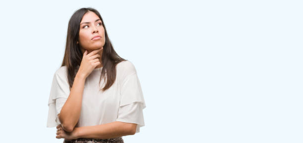 istock Young beautiful hispanic woman serious face thinking about question, very confused idea 1046570212