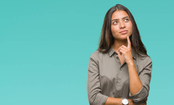 young beautiful arab woman over isolated background with hand on chin thinking about question, pensive expression. smiling with thoughtful face. doubt concept. - uncertainty imagens e fotografias de stock