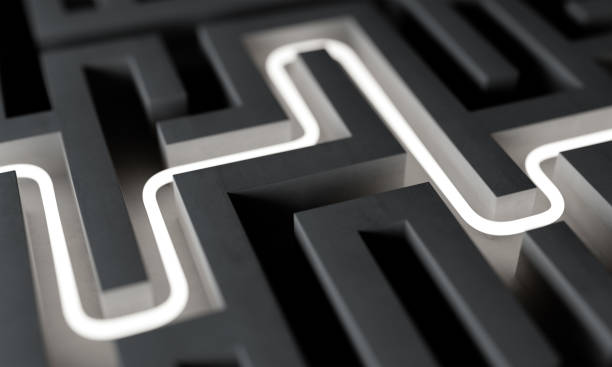 istock White neon path across abstract dark endless labyrinth 1046577388