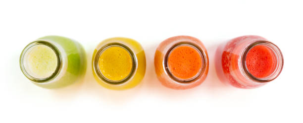 istock Colourful smoothie juice bottles isolated on white background 1046577444