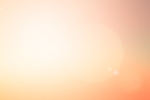 abstract blur glowing orange gold of morning  sky color tone background with white sunshine light effect for design as banner,presentation,ads concept