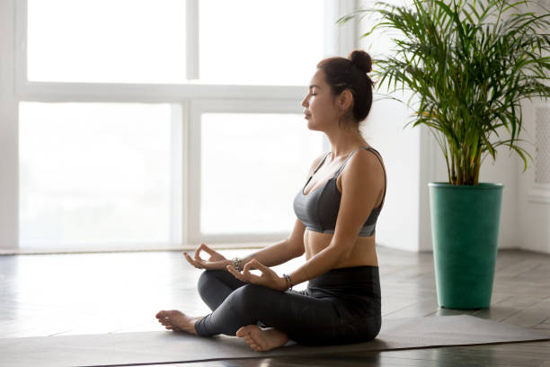 istock Young woman practicing yoga, doing Easy Seat exercise, Sukhasana pose, 1046581332