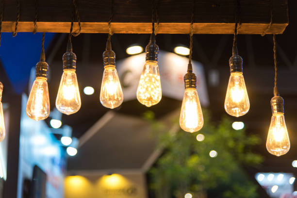 istock Close-Up Of Illuminated Light Bulbs Hanging From Ceiling 1046588762