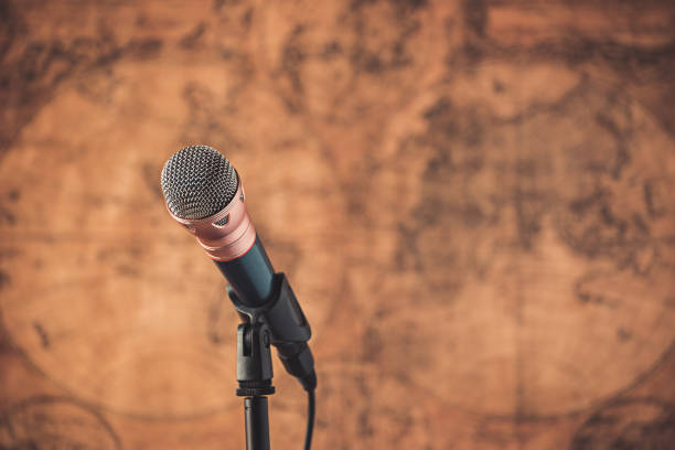 istock Close-Up Of Microphone Against Wall 1046590636