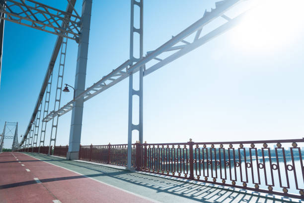istock Modern stylish bridge connecting two river banks 1046592052