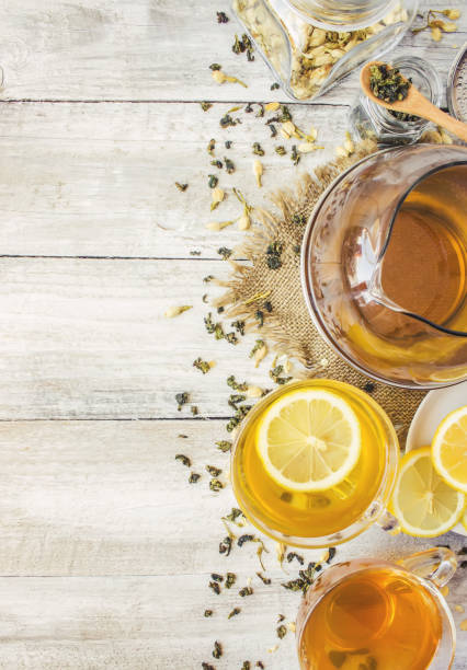 istock Green tea with Jasmine and black with transparent lemon in a small Cup on a light background. The tea maker. Selective focus. 1046599478