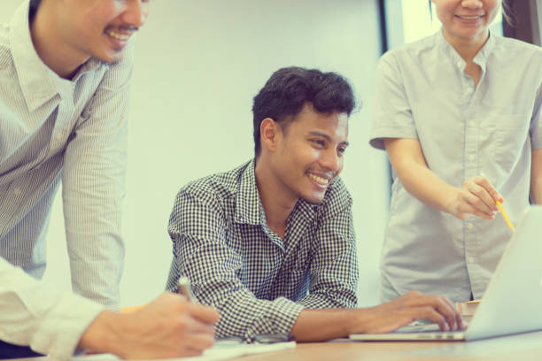 istock close up group of small engineering people (multi ethnic) working at private office room for studying or research project , consulting together and share idea for better teamwork concept 1046602524