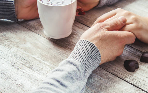 istock lovers holding together a Cup of tea. Selective focus. 1046603084