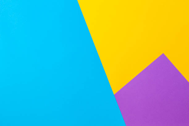 Color papers geometry flat composition background with yellow violet and blue tones