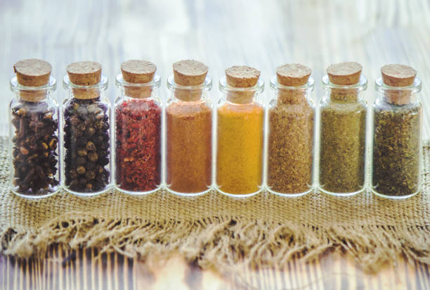 istock spices in jars on wooden background. selective focus. 1046610332