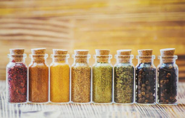 istock spices in jars on wooden background. selective focus. 1046610366
