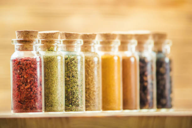 istock spices in jars on wooden background. selective focus. 1046610394