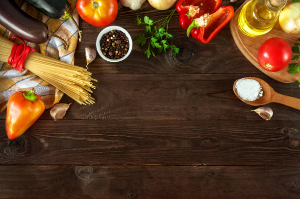 istock pasta with vegetables on a wooden background with free space for text. Top view. 1046616326