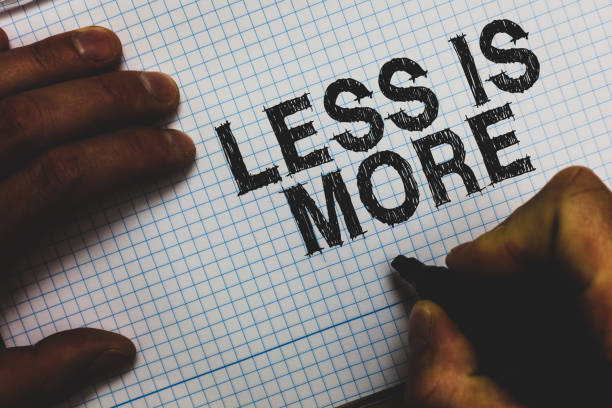 Handwriting text Less Is More. Concept meaning Minimalist approach to artistic matter is more effective Man holding marker communicating ideas important messages squared paper