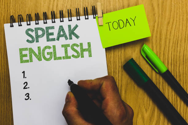 istock Word writing text Speak English. Business concept for Study another Foreign Language Online Verbal Courses Man holding marker notebook clothespin reminder wooden table cup coffee. 1046618290