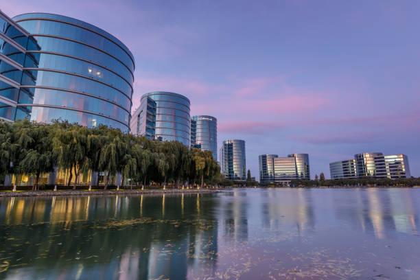Oracle headquarters with twilight skies in Redwood Shores, California. Redwood Shores, California - September 27, 2018: Oracle headquarters and lake with twilight skies. redwood city stock pictures, royalty-free photos & images