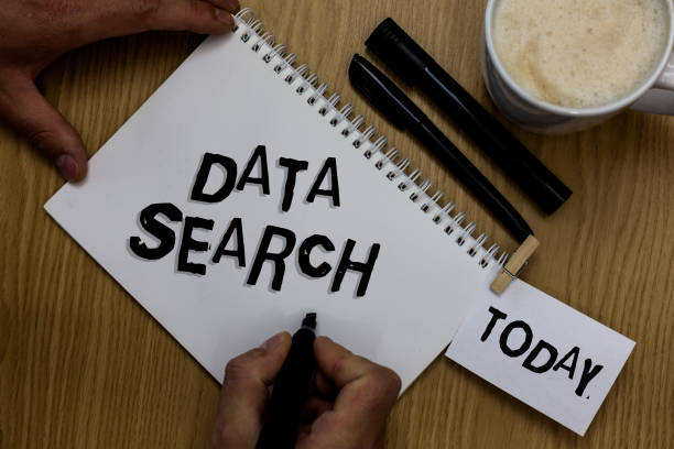 istock Writing note showing Data Search. Business photo showcasing gathers and reports information contains specified terms Man holding marker notebook clothepin reminder wooden table cup coffee. 1046619280