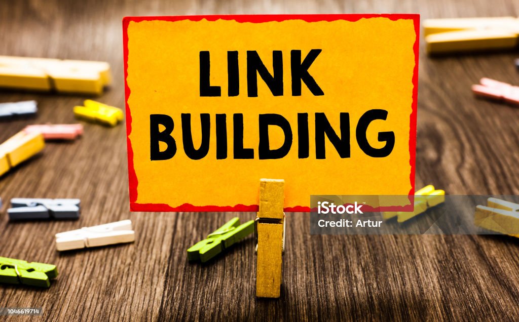 Conceptual hand writing showing Link Building. Business photo showcasing SEO Term Exchange Links Acquire Hyperlinks Indexed Clothespin holding orange paper note clothespin wooden floor. Conceptual hand writing showing Link Building. Business photo showcasing SEO Term Exchange Links Acquire Hyperlinks Indexed Clothespin holding orange paper note clothespin wooden floor Search Engine Stock Photo