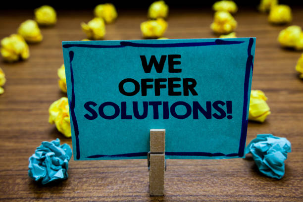 istock Handwriting text We Offer Solutions. Concept meaning Offering help assistance Experts advice strategies ideas Blurry wooden deck yellow and blue lob on ground paper clip grip page with text. 1046620052