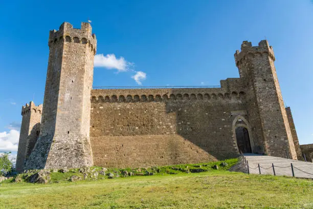 Fortress with fortified wall in Montalcino in Italy against clear blue sky on sunny day.