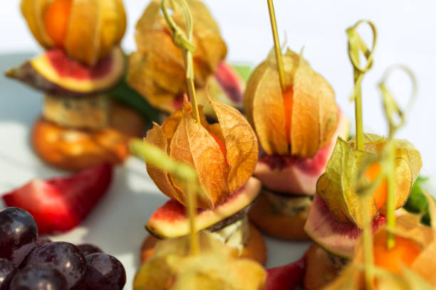 Canapes with physalis, fig, cheese and crackers