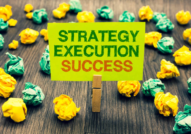 istock Word writing text Strategy Execution Success. Business concept for putting plan or list and start doing it well Clothespin holding yellow note paper crumpled papers several tries mistakes. 1046623086