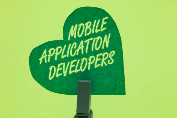 istock Conceptual hand writing showing Mobile Application Developers. Business photo showcasing create software for devices like Android Clothespin holding green paper heart romantic message ideas. 1046623470