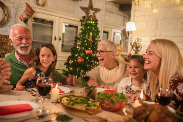 istock Smiling people with children having dinner together 1046628332