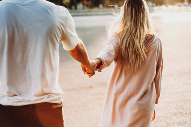 istock Crop couple holding hands on street 1046628516