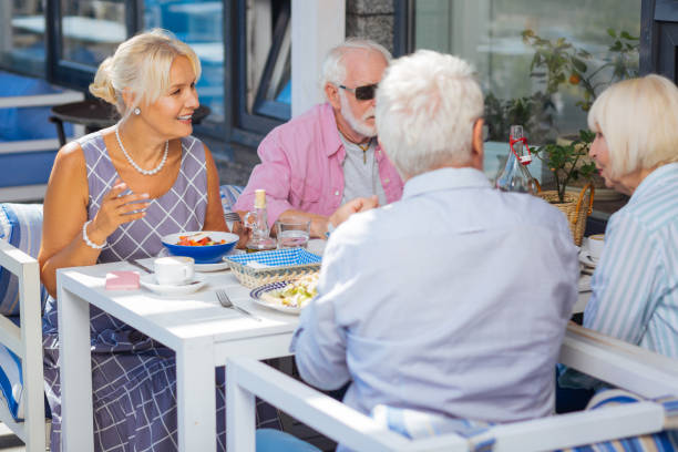 istock Nice aged people having dinner in the restaurant 1046635206