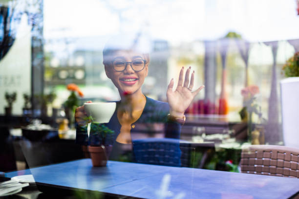 istock Asian female waiving from restaurant. 1046635394