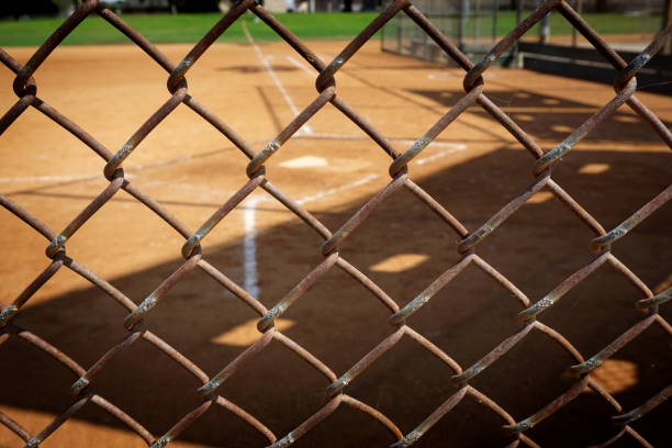 baseball field baseball field behind fence baseball cage stock pictures, royalty-free photos & images
