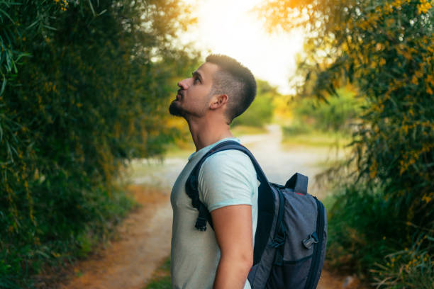 istock Portrait of a young backpacker man traveling in forest 1046646152