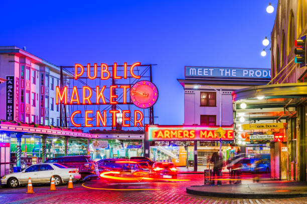Pike Place Market Seattle Seattle, Washington, USA - July 2; 2018: Pike Place Market at night. The popular tourist destination opened in 1907 and is one of the oldest continuously operated public markets in the United states. elliott bay photos stock pictures, royalty-free photos & images