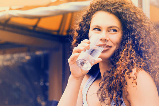 istock Happy woman drinking water 1046660788