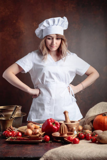 istock Young beautiful girl in a chef uniform . 1046663668