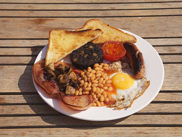 Full English Breakfast Outside on Wooden Table stock photo