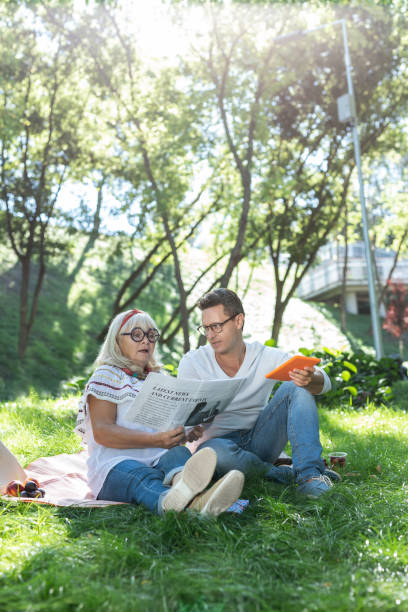 istock Relaxed blonde retired woman reading interesting article 1046667242