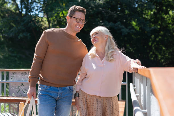 istock Handsome young male person supporting elderly woman 1046667444
