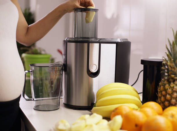 istock Pregnant woman at kitchen 1046673074