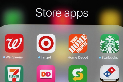 Grouping of popular restaurant and store mobile apps on an iPad screen. Apps include fast food restaurants such as Subway, Domino's, Dunkin Donuts and Starbucks as well as stores Walgreen, Target and The Home Depot.