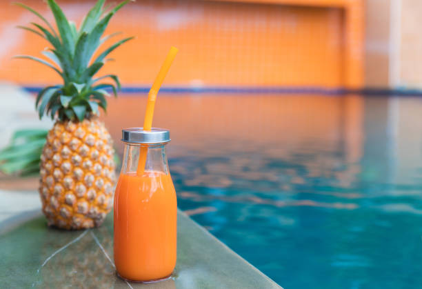 Fresh yellow pineapple tropic fruit summer refreshment smoothie shake drink near pool