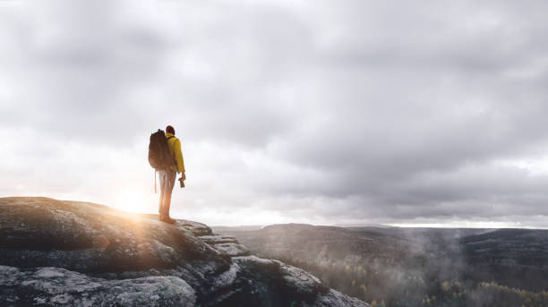 istock Hiker on a mountain at sunrise 1046680200