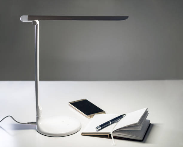 istock A smartphone and a diary with a pen on the table under the desktop LED lamp 1046680588