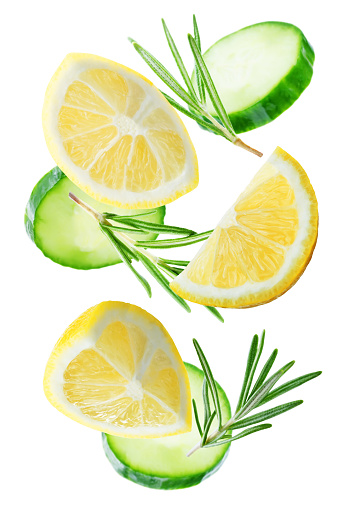 Flying Lemon slices with Cucumber slices and rosemary leaves on a white background. tinting. selective focus